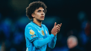 Rico Lewis applauding Manchester City fans during a match