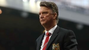 Louis van Gaal standing ahead of a Manchester United game at Old Trafford