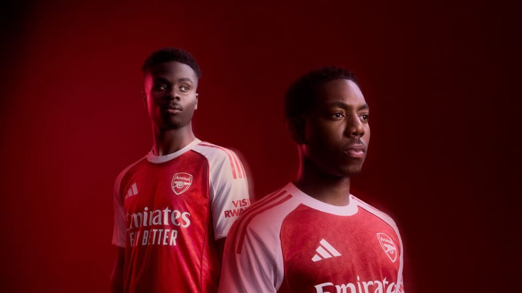 Bukayo Saka and Myles Lewis-Skelly posing in Arsenal's classy home kit