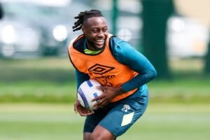 Bournemouth's Antoine Semenyo holding a ball and laughing during training