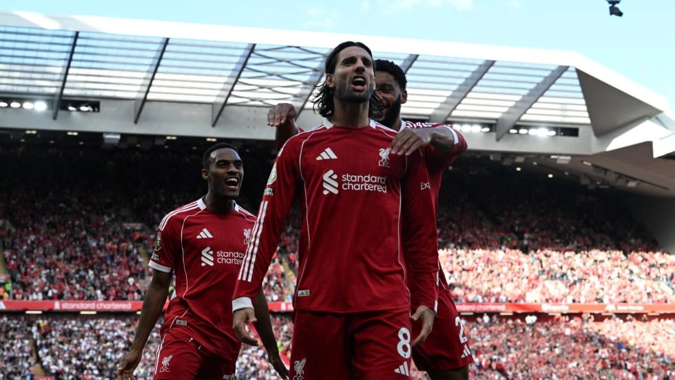 Liverpool midfielder Dominik Szoboszlai celebrating a goal with his teammates