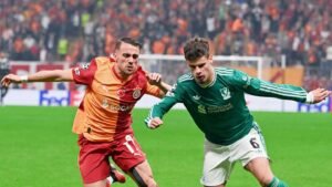 Liverpool defender Milos Kerkez vying for the ball with Galatasaray player