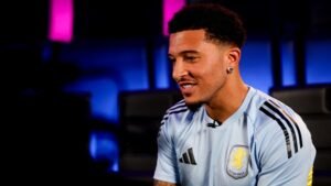 Jadon Sancho in an interview wearing an Aston Villa shirt