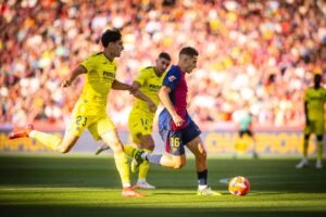 Barcelona midfielder Fermin Lopez vying with two Villareal players in a La Liga match