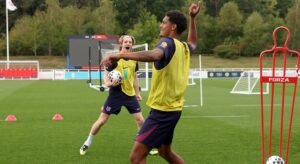 Jarell Quansah (foreground) on the England training ground with teammate Anthony Gordon.