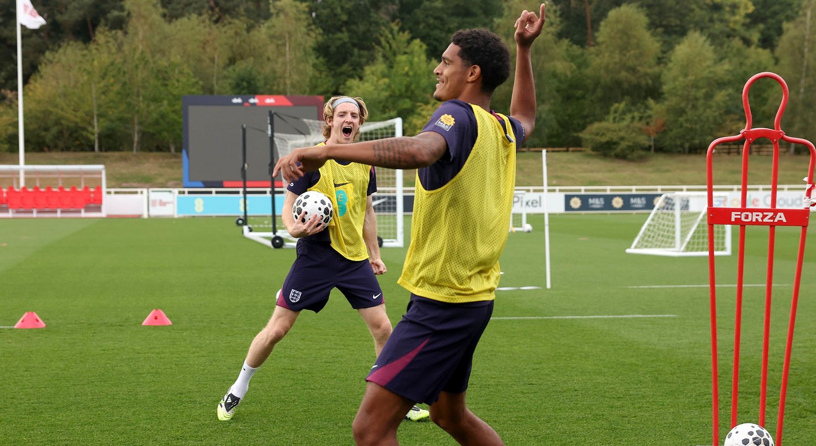 Jarell Quansah (foreground) on the England training ground with teammate Anthony Gordon.