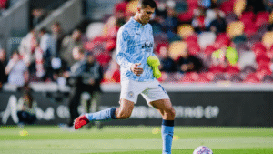 Manchester City midfielder Rodri kicking a ball during warm up