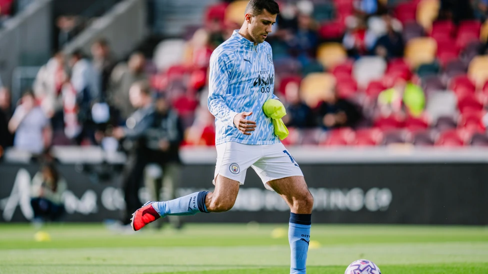 Manchester City midfielder Rodri kicking a ball during warm up