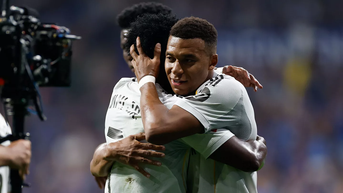 Real Madrid stars Kylian Mbappe and Vinicius Junior celebrating a goal with a big hug