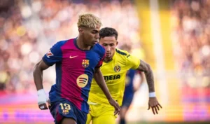 Barcelona winger Lamine Yamal trying to evade a Villareal player in a La Liga game