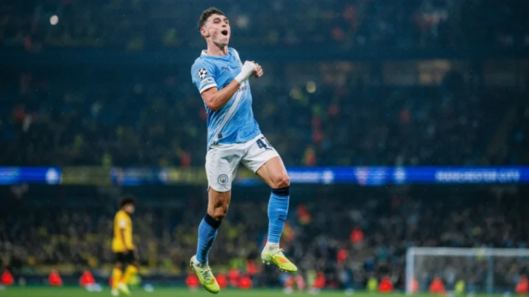 Manchester City's Phil Foden jumping in the air in celebration after scoring against Borussia Dortmund