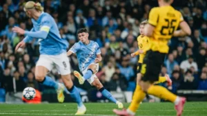 Manchester City's Phil Foden taking a shot against Borussia Dortmund