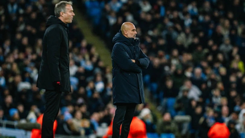 Manchester City boss Pep Guardiola standing beside his Bayer Leverkusen counterpart Kasper Hjulmand