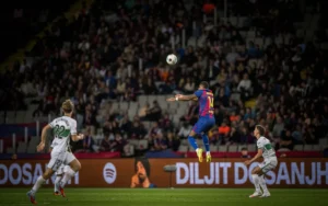 Barcelona winger Marcus Rashford leaping in the air to head a ball against Elche