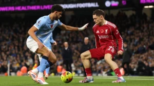 Liverpool midfielder Florian Wirtz vying for the ball with Manchester City's Matheus Nunes