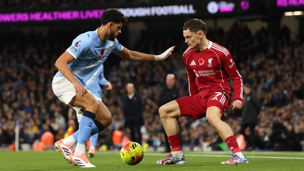 Liverpool midfielder Florian Wirtz vying for the ball with Manchester City's Matheus Nunes