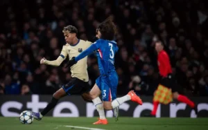 Barcelona's Lamine Yamal attempting to evade Chelsea's Marc Cucurella