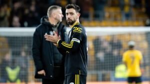 Bruno Fernandes applauding Manchester United fans in a stadium