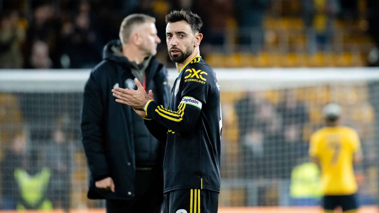 Bruno Fernandes applauding Manchester United fans in a stadium
