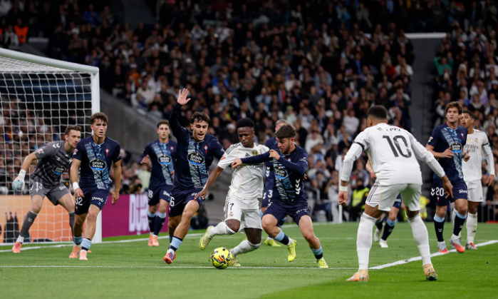 Real Madrid and Celta Vigo players vying for the ball