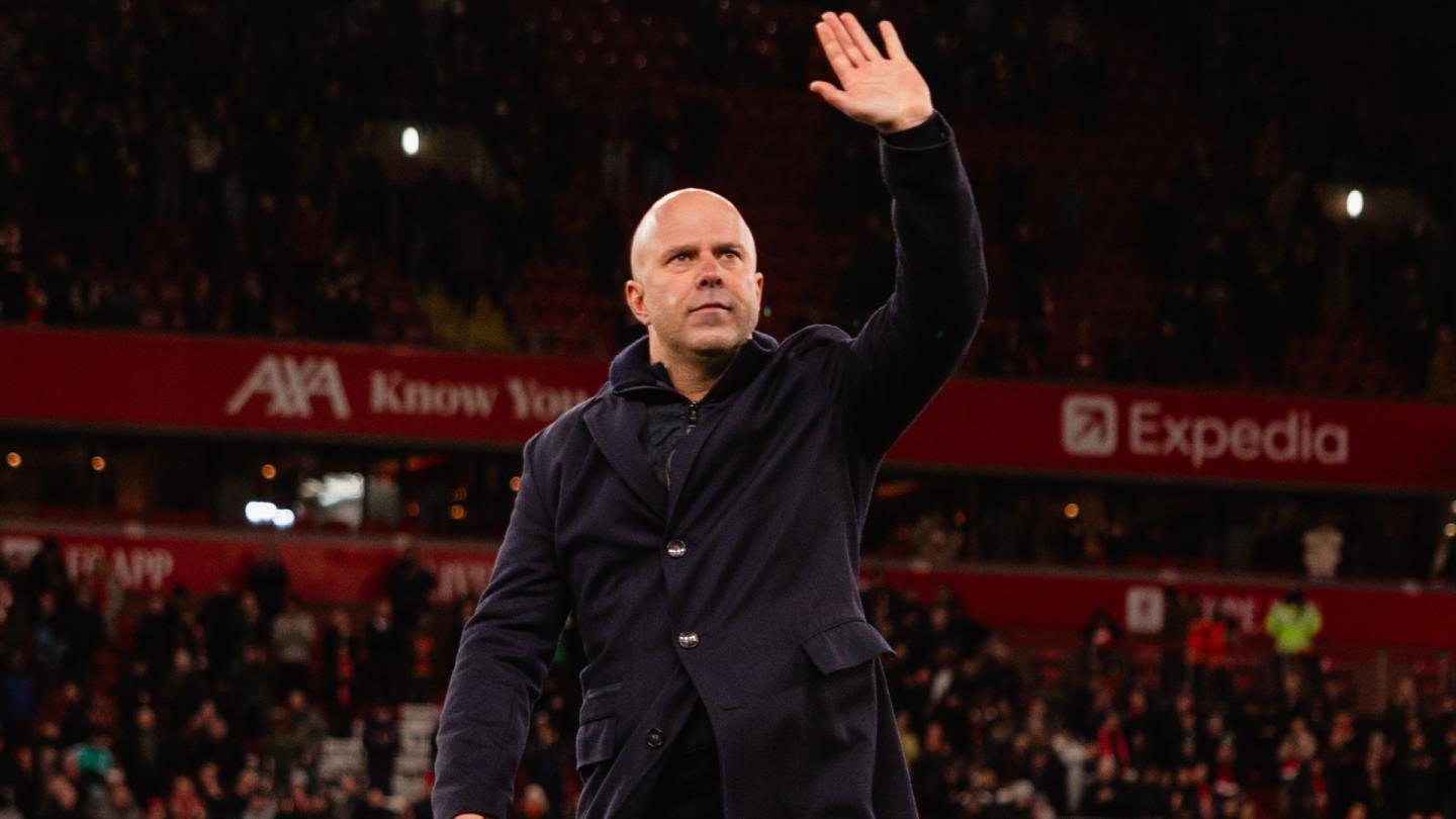 Arne Slot waving to Liverpool fans at Anfield