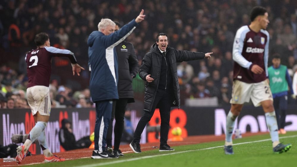 Unai Emery directing his Aston Villa players from the sidelines against Everton, with David Moyes standing by the side