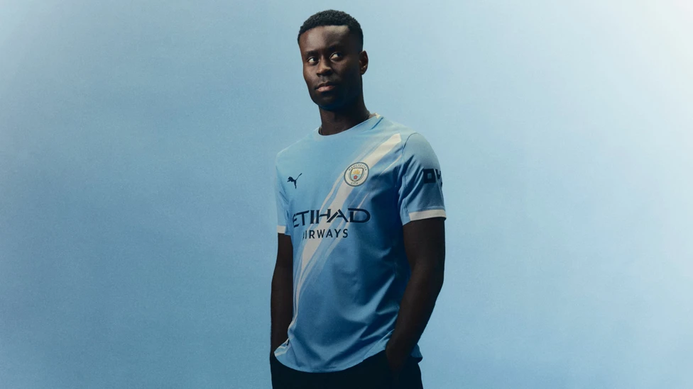 Marc Guehi posing in Manchester City shirt