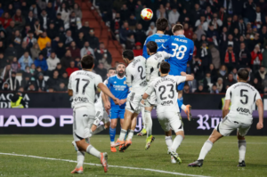 Real Madrid players contending the ball with Albacete players in their Copa del Rey clash