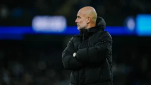 Manchester City manager Pep Guardiola standing on the sidelines