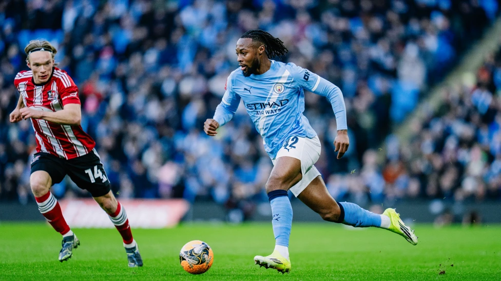 Manchester City's Antoine Semenyo dribbles past Exeter player in FA Cup game