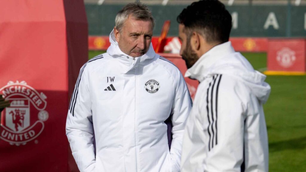Manchester United head coach Ruben Amorim and director of football Jason Wilcox standing on the training ground