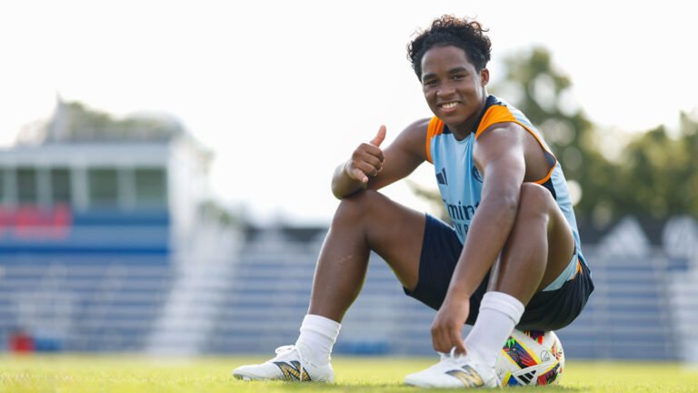 Endrick sitting on a ball at a training ground