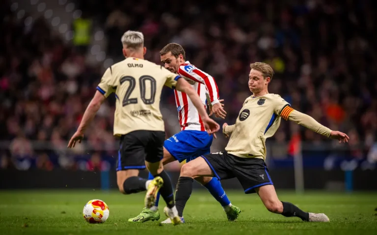 Barcelona players contesting the ball with Atletico Madrid's Antoine Griezmann