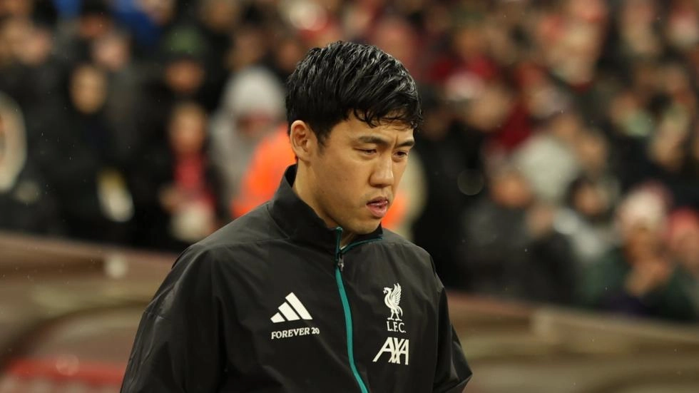 Wataru Endo walking in stadium in Liverpool jacket