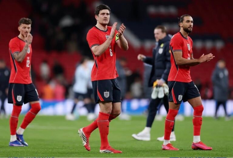 Harry Maguire applauding England fans at Wembley with his teammates