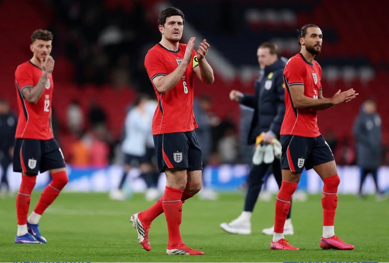 Harry Maguire applauding England fans at Wembley with his teammates