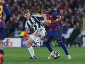 Newcastle defender Lewis Hall vying for the ball with Barcelona forward Lamine Yamal