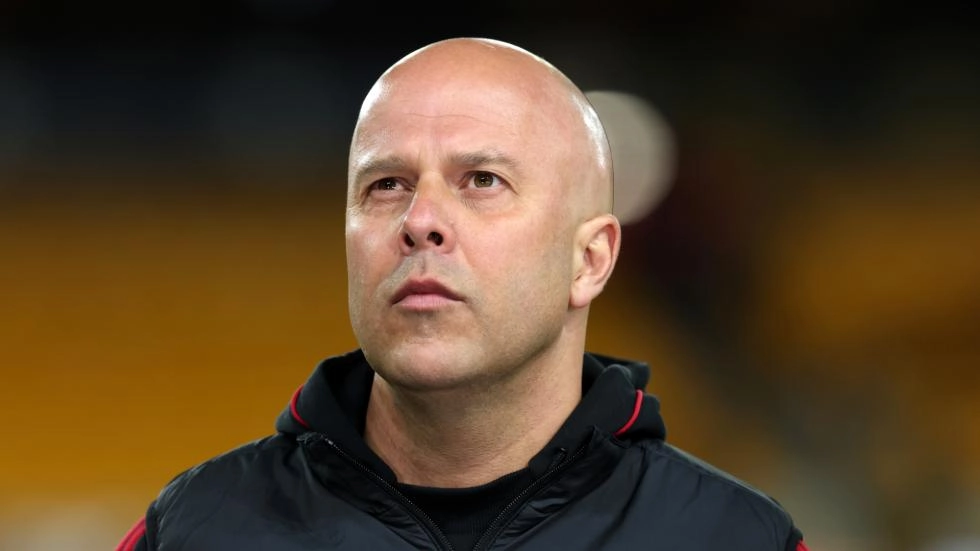 Arne Slot standing on the pitch after a Liverpool match