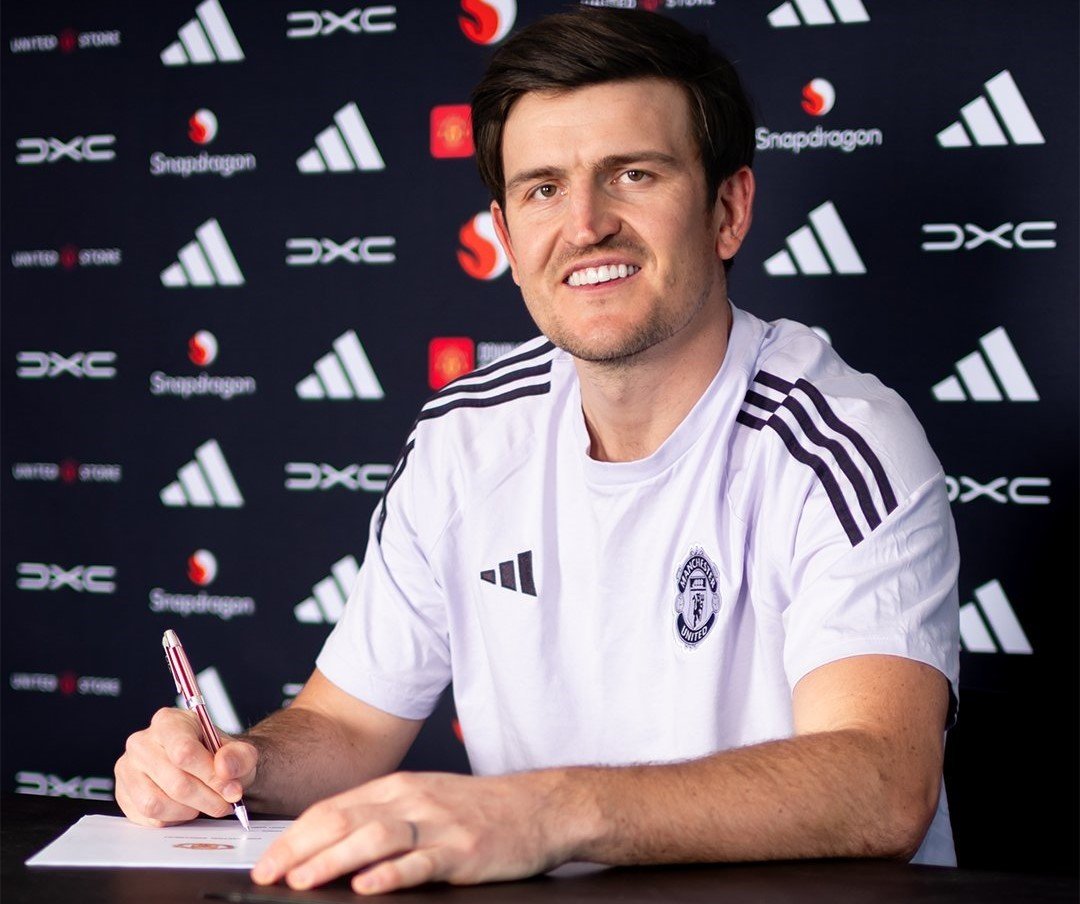 Harry Maguire signing a contract extension with Manchester United
