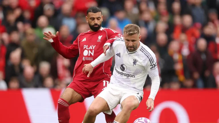 Manchester United defender Luke Shaw shielding the ball from Liverpool forward Mohamed Salah
