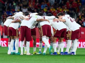 Spain players huddled on the pitch before a game