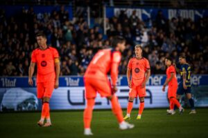 Barcelona players downcast after an away defeat