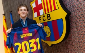 Anthony Gordon posing with a Barcelona jersey after signing for the club