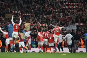 Arsenal players and coach Mikel Arteta celebrating in front of their fans