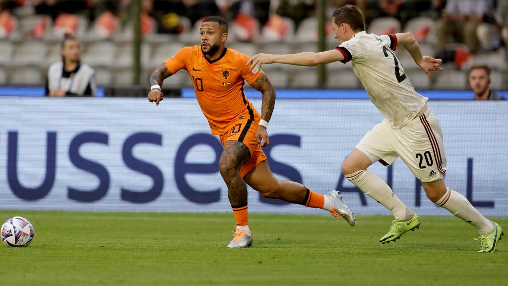 The Netherlands forward Memphis Depay evading a marker during a football game