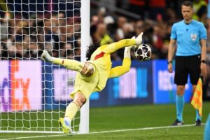 David Raya saving Nuno Mendes' penalty in the Champions League final.
