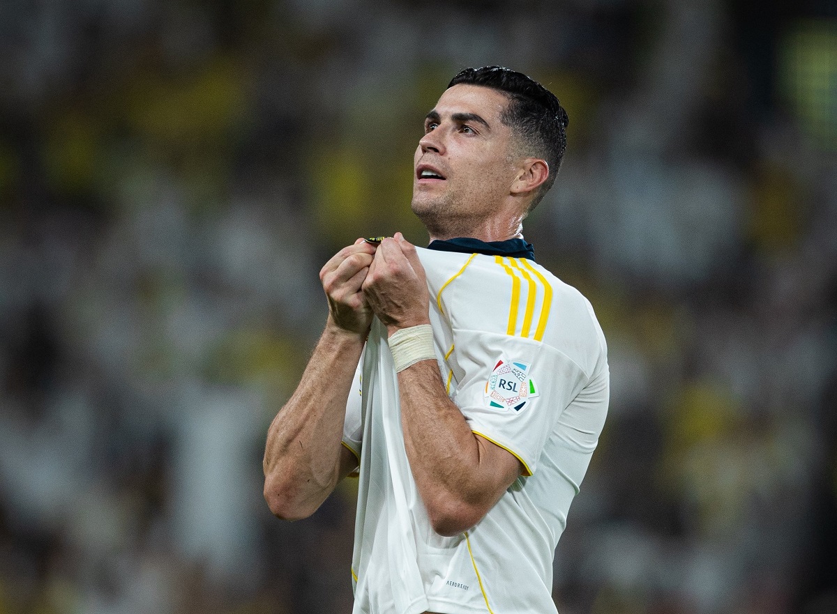 Cristiano Ronaldo celebrating by holding Al-Nassr badge
