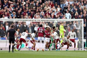 West Ham players vying for the ball at the goal post against Arsenal