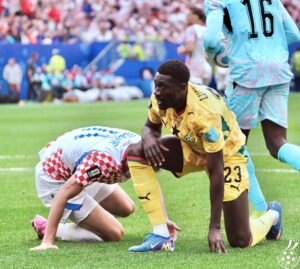 Ghana's Derrick Luckassen on the deck beside Croatia player
