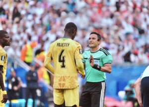 Ghana defender speaking to the referee during game against England